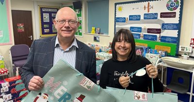 Staffordshire County Council Cabinet member Mark Sutton and SEND team member Melissa Martin preparing some presents for distribution